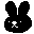 A black bunny moves its ears from side to side.